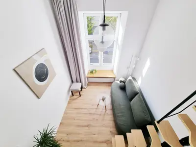 a living room with a couch and a window at Nad Szklarnią in Kraków