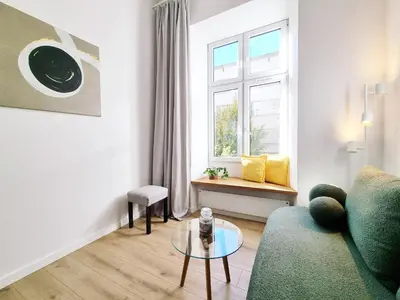 a living room with a couch and a glass table at Nad Szklarnią in Kraków
