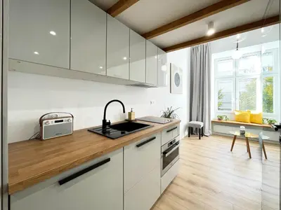 a kitchen with white cabinets and a sink at Nad Szklarnią in Kraków