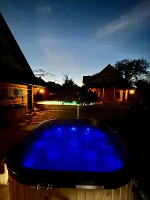 a blue hot tub in a yard at night at Zacisze Pod Lipą in Andrychów