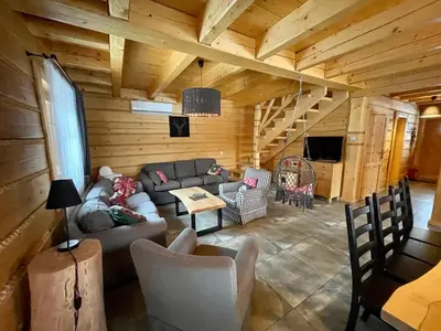 a living room with a couch and chairs in a cabin at Zacisze Pod Lipą in Andrychów