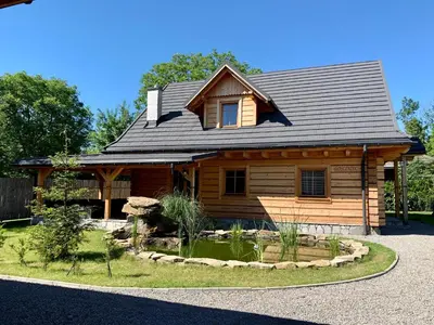 a house with a swimming pool in front of a house at Zacisze Pod Lipą in Andrychów