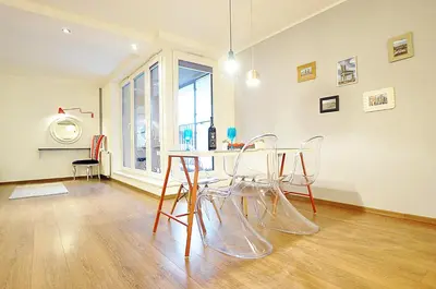 a dining room with a table and chairs at Designomania Apartments - Nadwiślańska 11 in Kraków