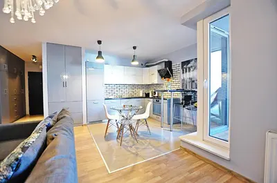 a living room with a couch and a table at Designomania Apartments - Nadwiślańska 11 in Kraków