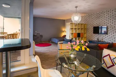 a living room with a table and a couch at Designomania Apartments - Nadwiślańska 11 in Kraków