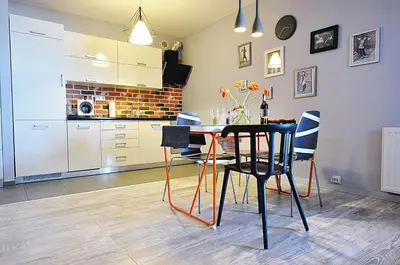 a dining room with a table and some chairs at Designomania Apartments - Nadwiślańska 11 in Kraków