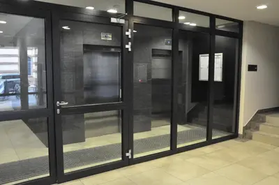 a group of glass doors in a building at Designomania Apartments - Nadwiślańska 11 in Kraków