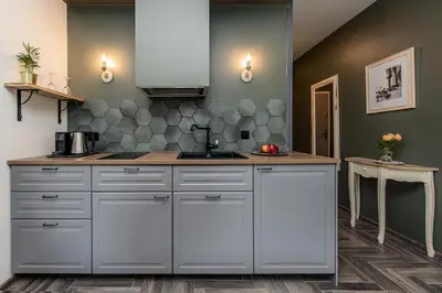 a kitchen with white cabinets and a sink at Rajska Old Town Suites in Kraków