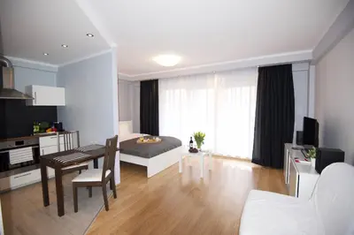 a living room with a kitchen and a dining room at Kraków Apartments - Friedleina Studio Apartments in Kraków