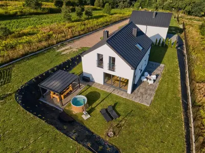 an overhead view of a white house with a picnic table at Stodołówka in Budzów