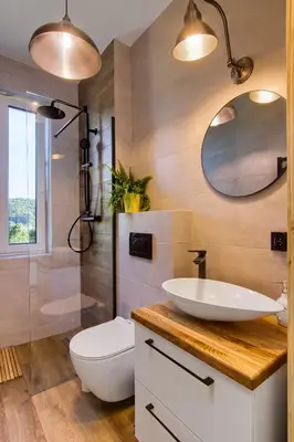 a bathroom with a sink and a toilet and a mirror at Stodołówka in Budzów