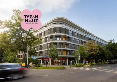 a building on a street with a car driving past it at Luxury two-bedroom apartment with terrace by Tyzenhauz in Kraków