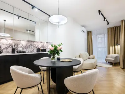 a living room with a table and chairs at Luxury two-bedroom apartment with terrace by Tyzenhauz in Kraków