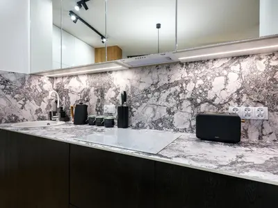 a kitchen with a marble counter with a sink at Luxury two-bedroom apartment with terrace by Tyzenhauz in Kraków