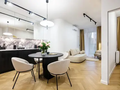 a living room with a table and chairs at Luxury two-bedroom apartment with terrace by Tyzenhauz in Kraków