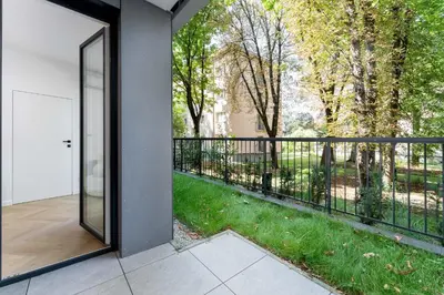 a glass door leading to a balcony with a yard at Luxury two-bedroom apartment with terrace by Tyzenhauz in Kraków