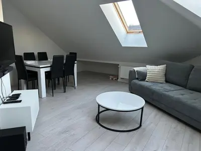 a living room with a couch and a table at Villa Kraków in Kraków
