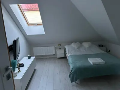 a bedroom with a bed and a television in a attic at Villa Kraków in Kraków