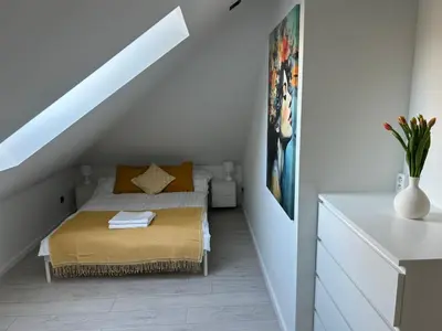 a small bedroom with a bed in a attic at Villa Kraków in Kraków
