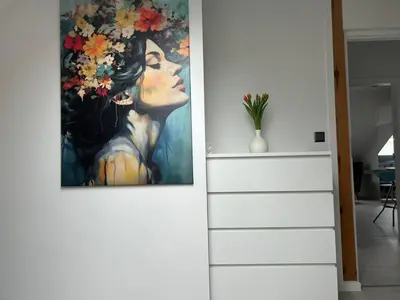 a painting of a woman with flowers on a wall at Villa Kraków in Kraków