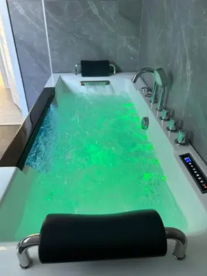 a bath tub filled with water in a bathroom at Villa Kraków in Kraków