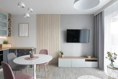 a living room with a white table and chairs at Apartament Szary in Kraków