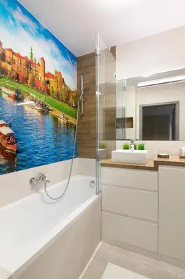 a bathroom with a painting of a river at Apartament Szary in Kraków