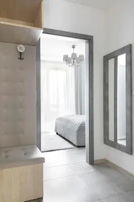 a bathroom with a mirror and a bed and a sink at Apartament Szary in Kraków