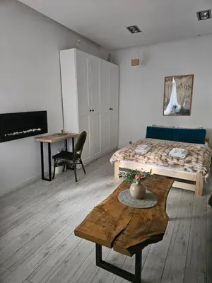 a room with a bed and a coffee table in it at Modern apartament in the Old Town in Kraków