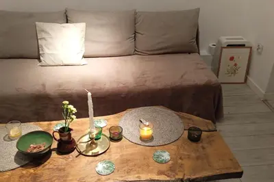 a coffee table with candles on top of a bed at Modern apartament in the Old Town in Kraków