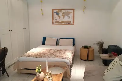 a bedroom with a bed and a table and a couch at Modern apartament in the Old Town in Kraków
