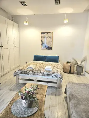 a bedroom with a bed and a table in it at Modern apartament in the Old Town in Kraków