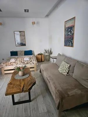 a living room with a couch and a bed at Modern apartament in the Old Town in Kraków