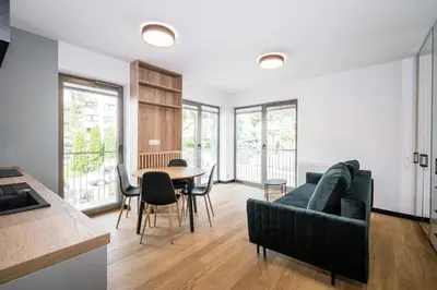 a living room with a couch and a table at Dodo Acomodo 7 in Kraków