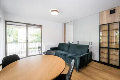 a living room with a couch and a table at Dodo Acomodo 7 in Kraków