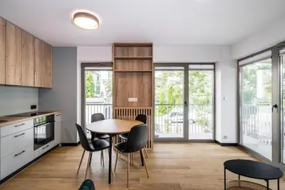 a kitchen and dining room with a table and chairs at Dodo Acomodo 7 in Kraków