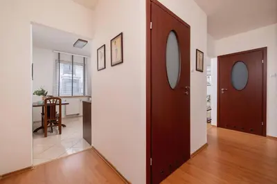 a hallway with two doors and a dining room at Bright Apartment near ICE Kraków with Air Conditioning and Parking by Noclegi Renters in Kraków