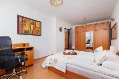 a bedroom with a bed and a desk and a chair at Bright Apartment near ICE Kraków with Air Conditioning and Parking by Noclegi Renters in Kraków