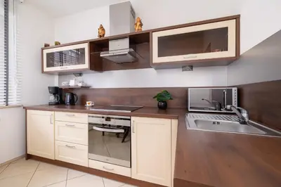 a kitchen with a sink and a counter top at Bright Apartment near ICE Kraków with Air Conditioning and Parking by Noclegi Renters in Kraków