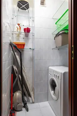 a small laundry room with a washer and dryer at Bright Apartment near ICE Kraków with Air Conditioning and Parking by Noclegi Renters in Kraków