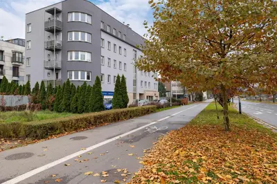 an empty street in front of a building at Bright Apartment near ICE Kraków with Air Conditioning and Parking by Noclegi Renters in Kraków