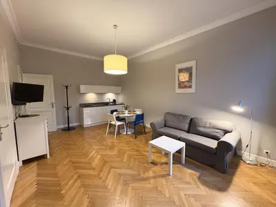 a living room with a couch and a table at Central Place Warszawska in Kraków
