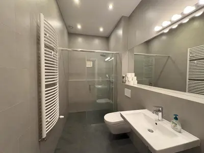 a bathroom with a toilet and a sink and a shower at Central Place Warszawska in Kraków