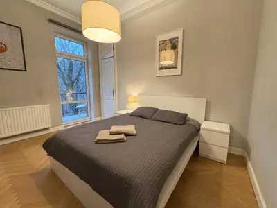 a bedroom with a bed with two towels on it at Central Place Warszawska in Kraków