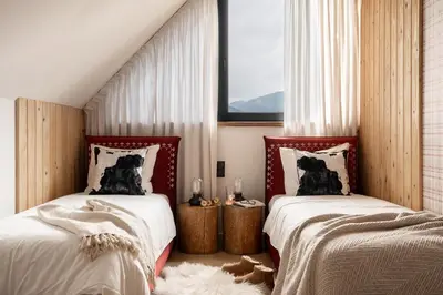 a dog laying on a bed in a bedroom at Sunset House in Poręba Wielka