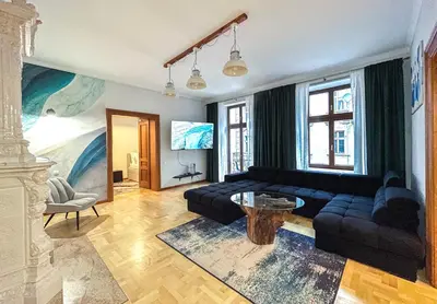 a living room with a couch and a table at Old Town Kraków - Unique Apartment Euphorie in Kraków