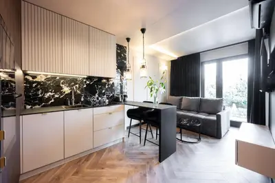 a kitchen with a table and a couch in a room at Native Apartments Kościuszki 39I24 in Kraków