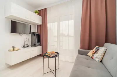 a living room with a couch and a tv at Prądnik Czerwony Studio - Balcony, City View - by Rentujemy in Kraków