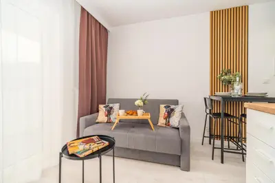 a living room with a couch and a table at Prądnik Czerwony Studio - Balcony, City View - by Rentujemy in Kraków