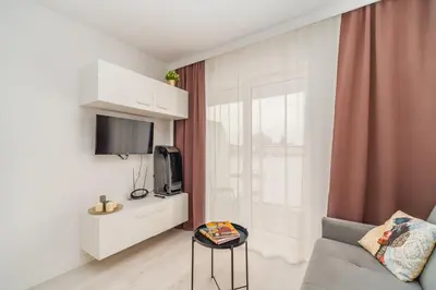 a small living room with a couch and a tv at Prądnik Czerwony Studio - Balcony, City View - by Rentujemy in Kraków